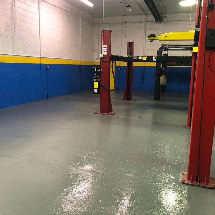 Clean service bay with red two-post lifts