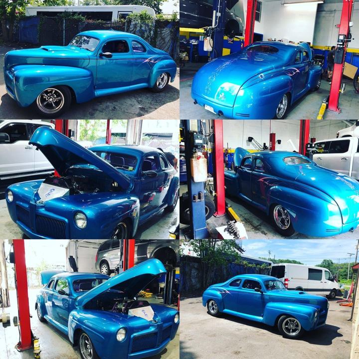 A blue classic car being worked on in our shop